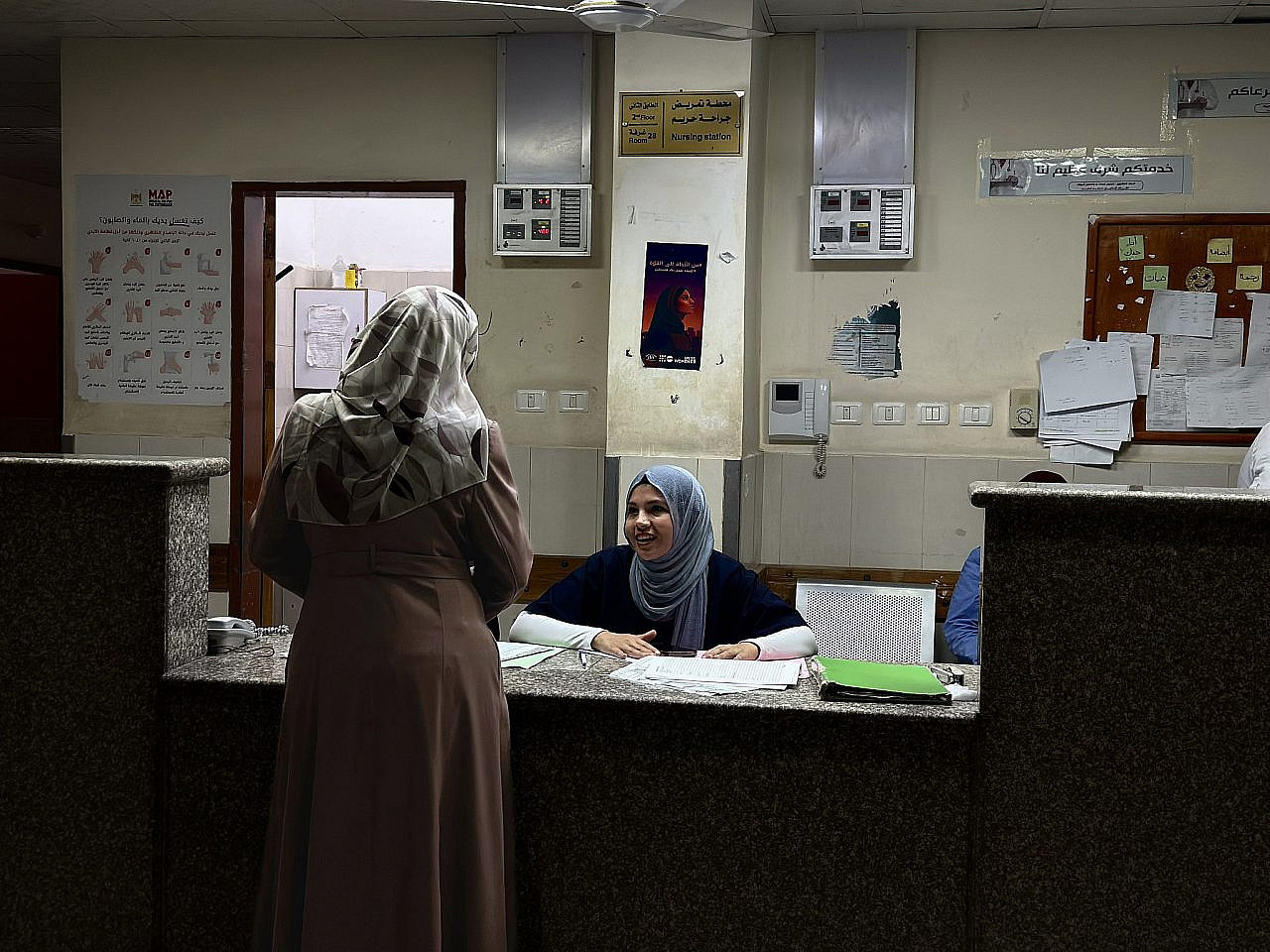 Hospital staff work in a room with limited lights as the electricity crisis and shortage of supplies is endangering patients' lives, Nasser Medical Complex, Khan Younis, Gaza Strip, June 20, 2026. (Activestills/Doaa Albaz)