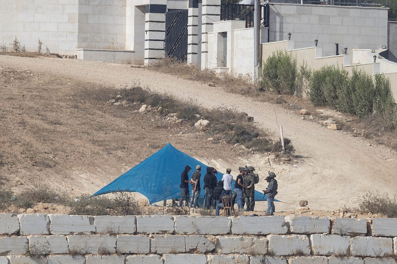 Israeli settlers seen besieging the Abu Ridi home in Qusra, occupied West Bank, August 14, 2026. (Oren Ziv)