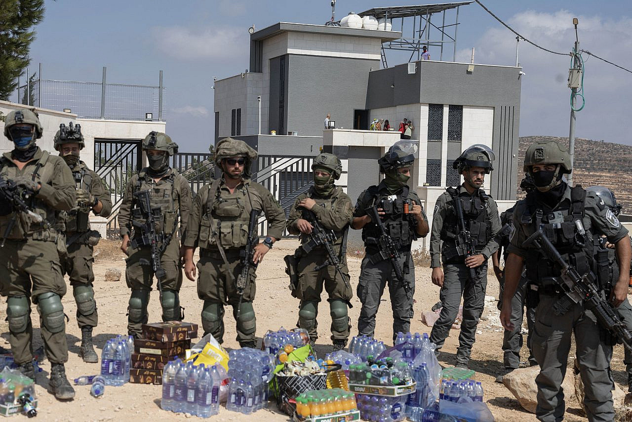 Israeli soldiers block activists from delivering supplies to the home of Qusai Abu Ridi in Qusra, occupied West Bank, August 14, 2026. (Oren Ziv)