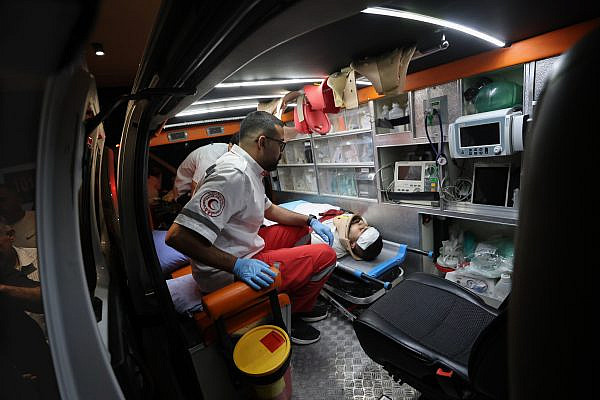 Mohammed Mutafer, a nurse, is treated by medics after Israeli settlers shot and injured him and two other Palestinians during an attack on the town of Sa'ir, east of Hebron (Al-Khalil) in the southern West Bank, August 14, 2026. (Mosab Shawer/Activestills)