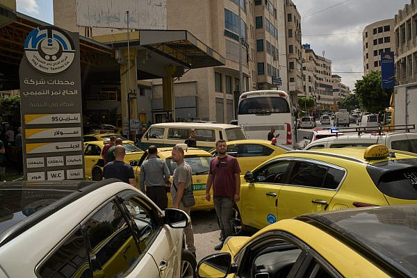 Palestinian taxi drivers gather at a gas station amid a fuel shortage in the West Bank city of Nablus, July 26, 2026. (AP Photo/Leo Correa)