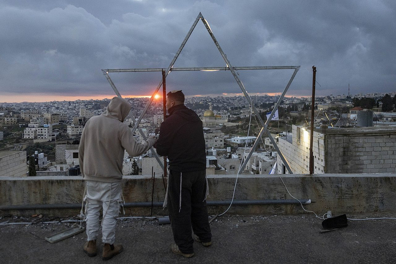 Jewish settlers are seen in the HaGvura neighborhood in the occupied West Bank city of Hebron, February 24, 2026. (Chaim Goldberg/Flash90)