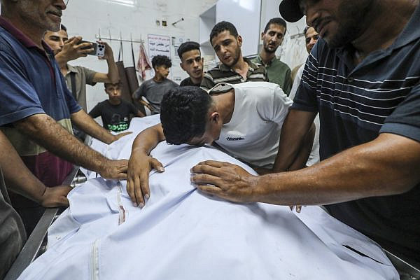 Family members bid farewell to loved ones killed in an Israeli strike in central Gaza City, at Al-Shifa Hospital, August 31, 2026. (Yousef Zaanoun/Activestills)