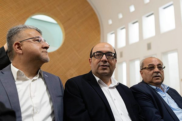 Balad chairman Sami Abu Shehadeh, surrounded by MK Ahmad Tibi and Joint List chairman Yousef Jabareen, at the Supreme Court in Jerusalem for a hearing on the Central Elections Committee’s decision to disqualify candidates and parties from running in the upcoming Knesset elections, October 1, 2026. (Oren Ziv)