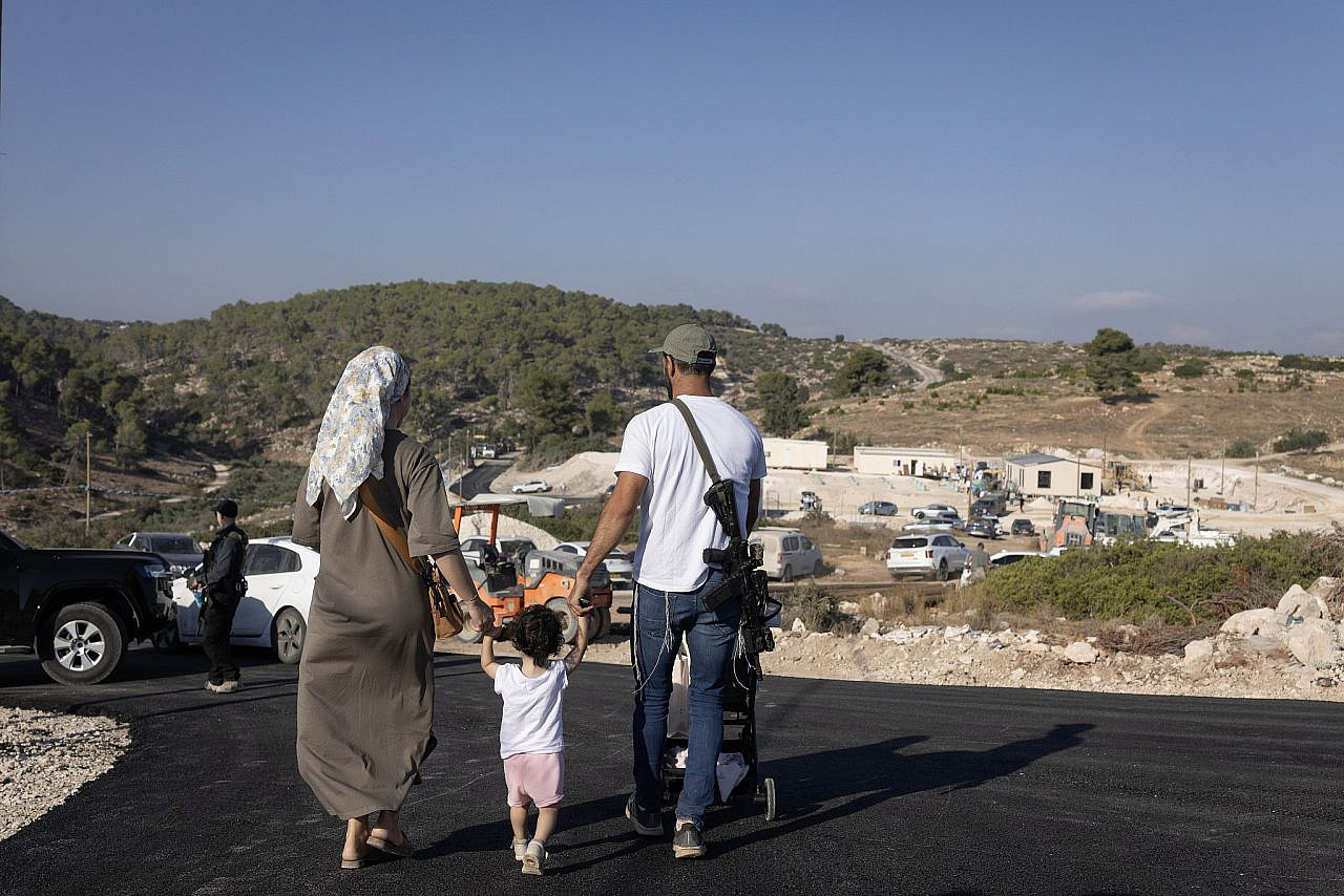 Israeli settlers, some of them armed, move into new housing units in the re-established settlement of Ganim, near Jenin in the occupied West Bank, August 13, 2026. (Oren Ziv)