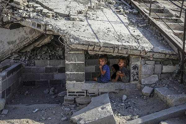 Palestinian children return to their home after it was destroyed by the Israeli army, in Khan Younis, southern Gaza, November 1, 2025. (Abed Rahim Khatib/Flash90)