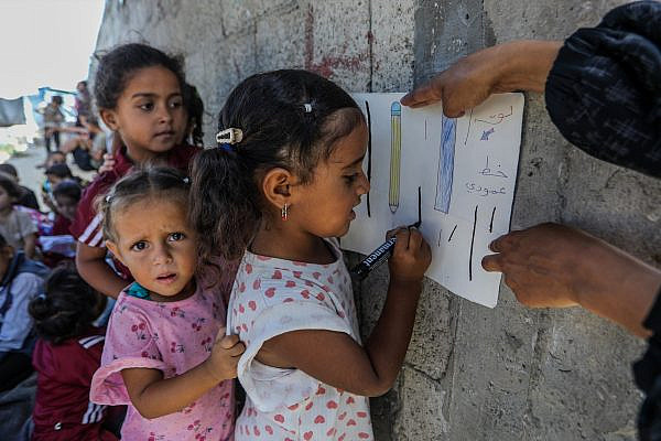 Palestinian children attend class at Al-Amal Kindergarten, at a cemetery in Khan Younis, in the southern Gaza Strip, September 22, 2026. (Abed Rahim Khatib/Flash90)