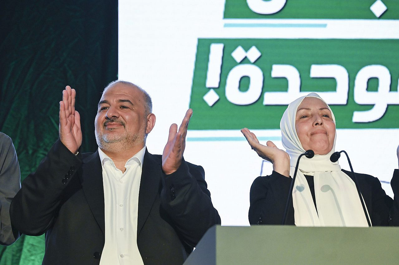 United Arab List (Ra’am) chairman Mansour Abbas stands alongside fellow party members on stage following the release of exit poll results on Israel's election night, in the northern Israeli city of Sakhnin, October 27, 2026. (Michael Giladi/Flash90)