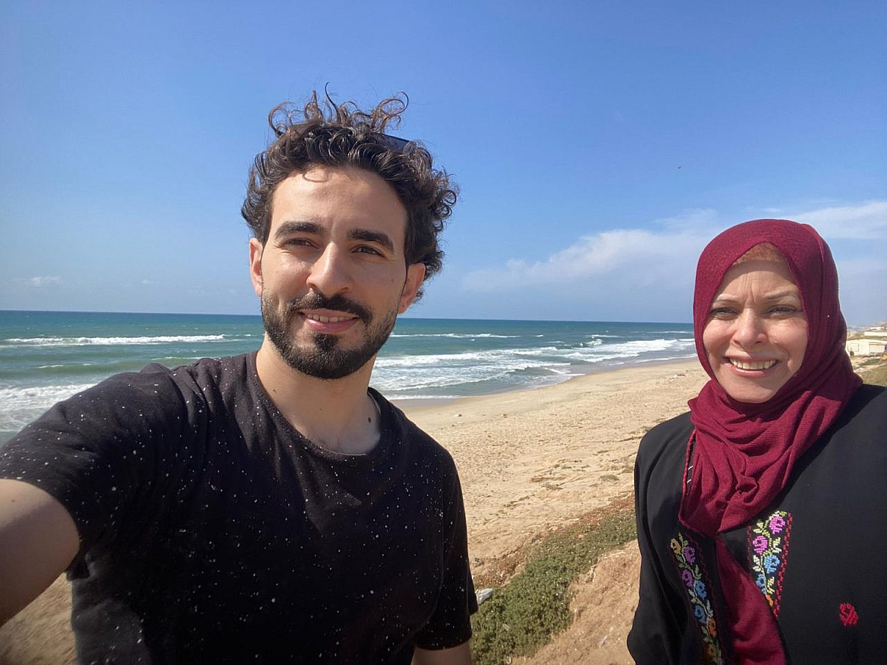 The author, pictured with his mother, Suzane, on a walk by the beach in Gaza. Suzane passed away in Cairo after a year of cancer treatment in Spring 2025, May 15, 2023. (Ahmed Dremly) The author, pictured with his mother, Suzane, on a walk by the beach in Gaza. Suzane passed away in Cairo after a year of cancer treatment in Spring 2025, May 15, 2023. (Ahmed Dremly)