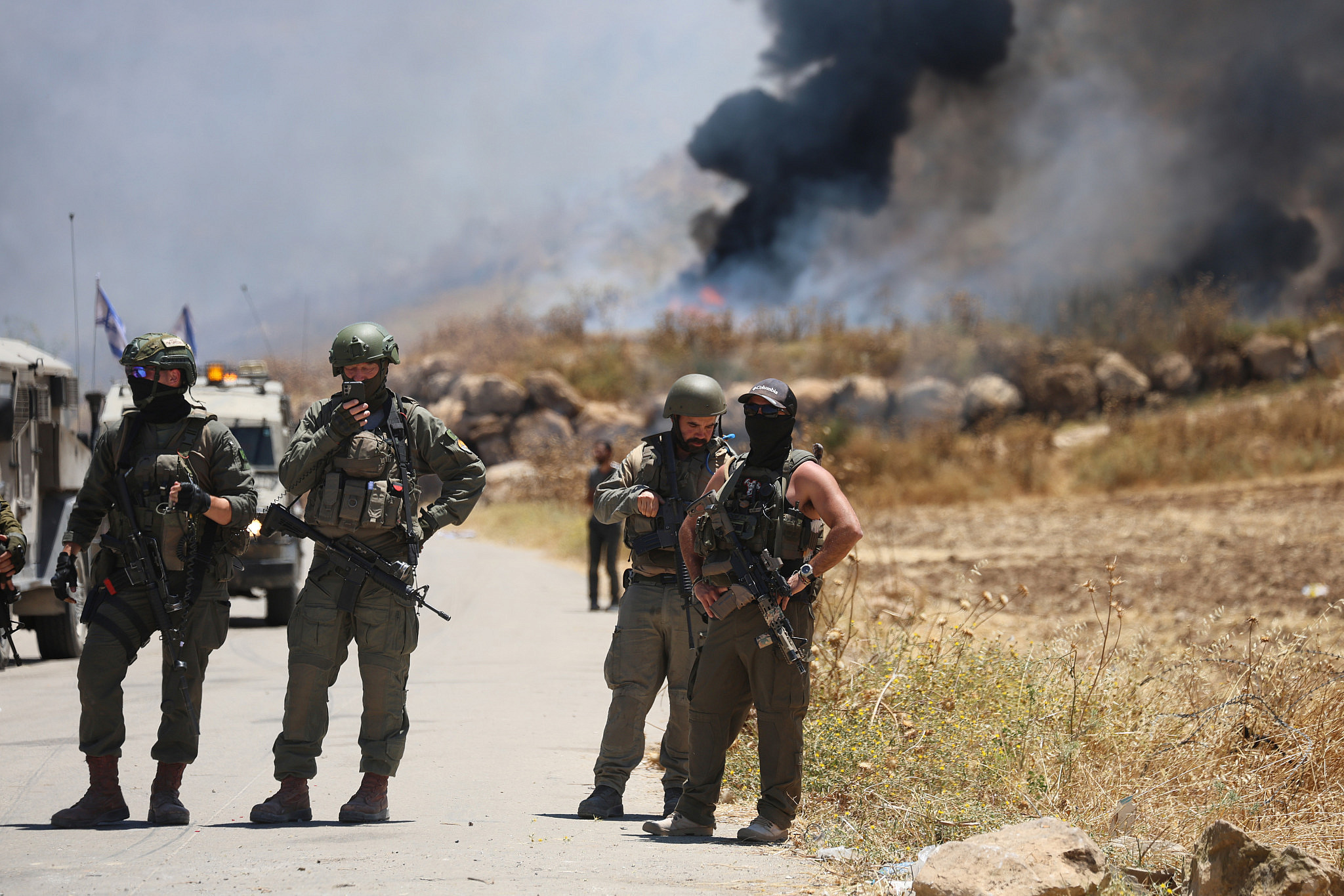 Israeli forces prevent Palestinians from reaching their land in the occupied West Bank village of Idhna, where Israeli settlers had burned their crops, May 5, 2026. (Mosab Shawer/Activestills) Israeli forces prevent Palestinians from reaching their land in the occupied West Bank village of Idhna, where Israeli settlers had burned their crops, May 5, 2026. (Mosab Shawer/Activestills)
